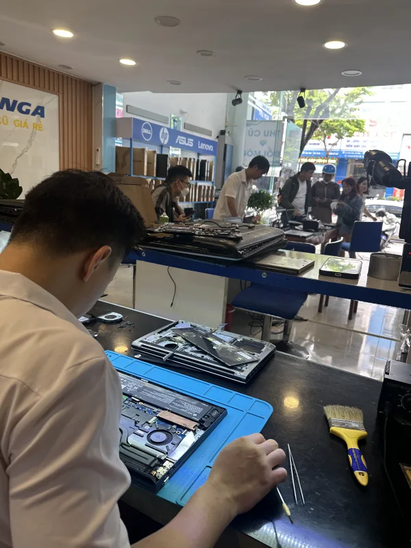 Kỹ thuật viên Thanh Nga tháo máy và sửa chữa linh kiện bên trong laptop